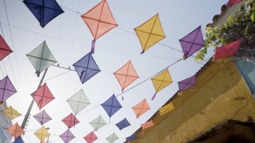 Kites hang above a street in Cartagena
